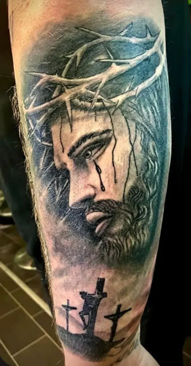 Black and grey religious tattoo of Christ with a crown of thorns and three crosses by Ivan Todorov, N9 Tattoo, Edmonton