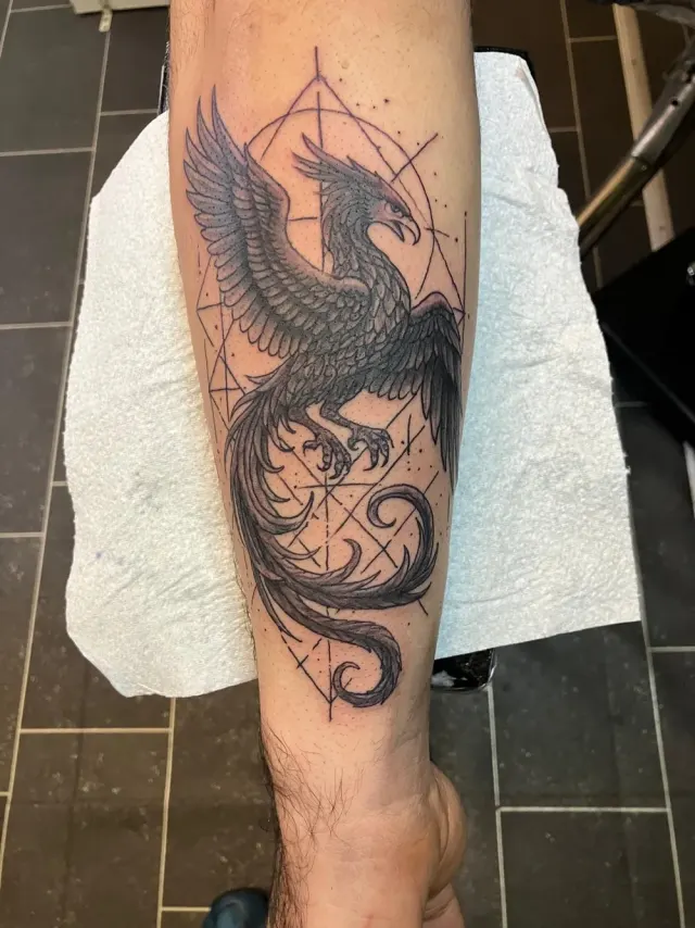 Black and grey phoenix tattoo with sacred-geometry linework, N9 Tattoo, North London