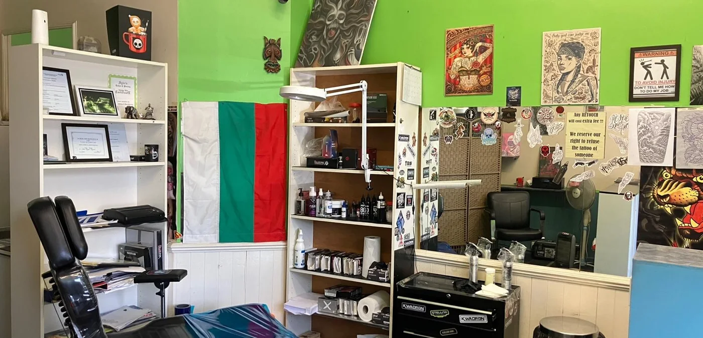 Inside N9 Tattoo Studio in Edmonton — the workstation, inks and flash art on the walls